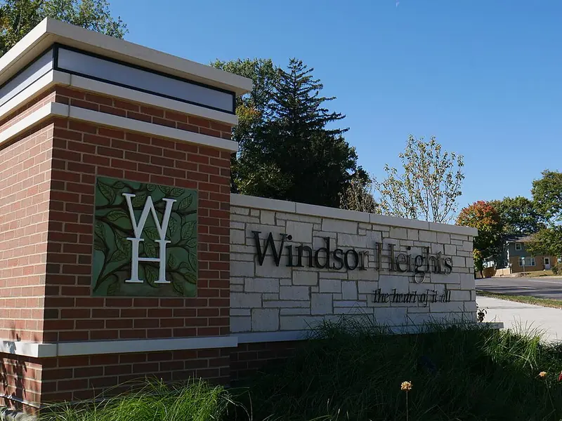 Brick and stone Windsor Heights city entry sign beside a landscaped lawn